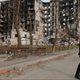 A local resident walks near an apartment building destroyed during Ukraine-Russia conflict in the besieged southern port city of Mariupol, Ukraine March 30, 2022.